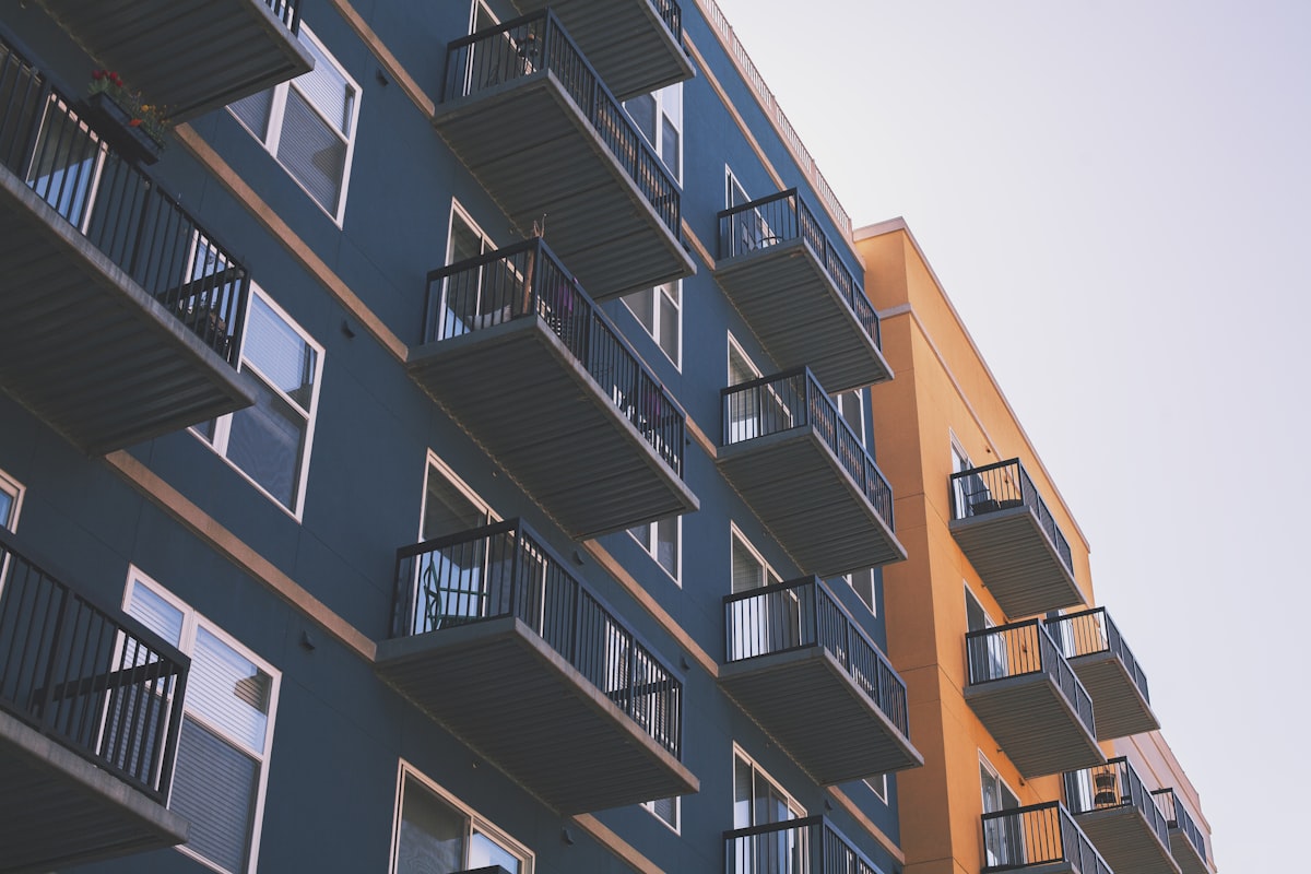 A multi-storey condominium building with balconies